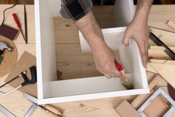 man-creating-cabinet-from-wood-top-view